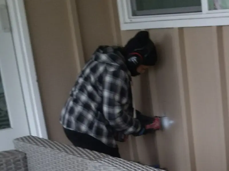 Professional electrician installing an exterior outlet in New Castle