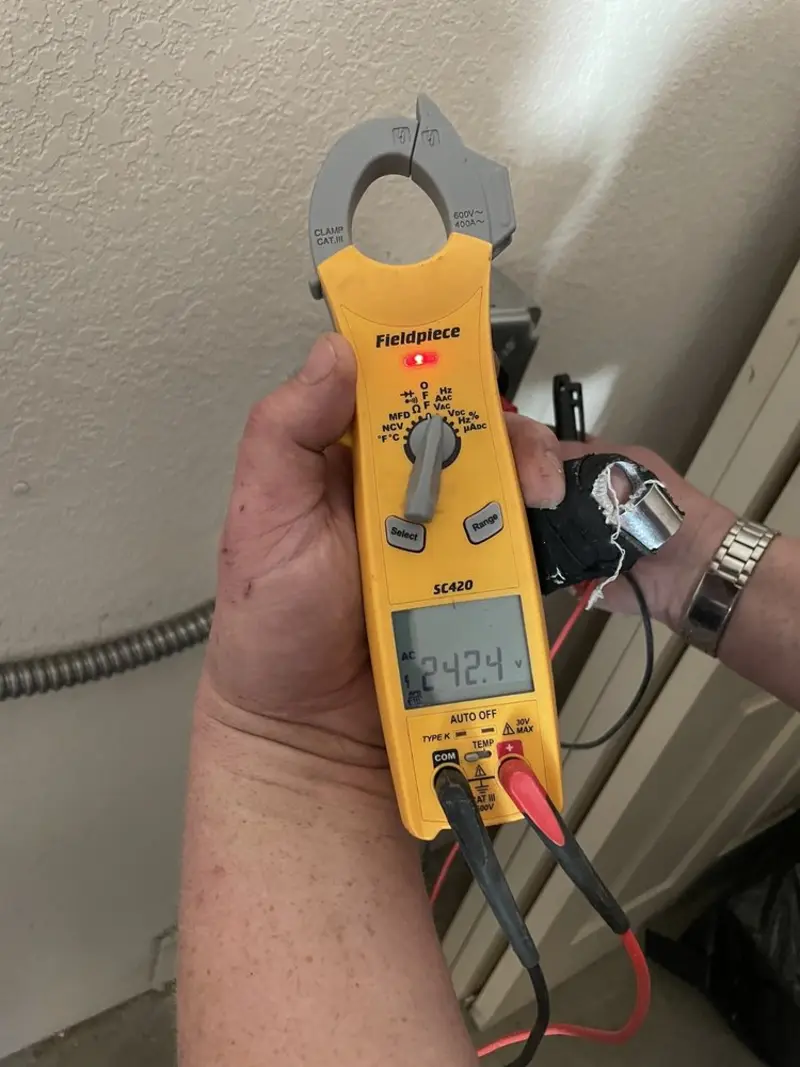 Voltage testing with clamp meter during Whole House Surge Protector in New Castle